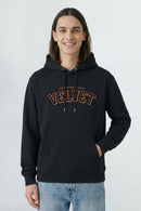 Person wearing a black hoodie with 'Velvet' text on a light background