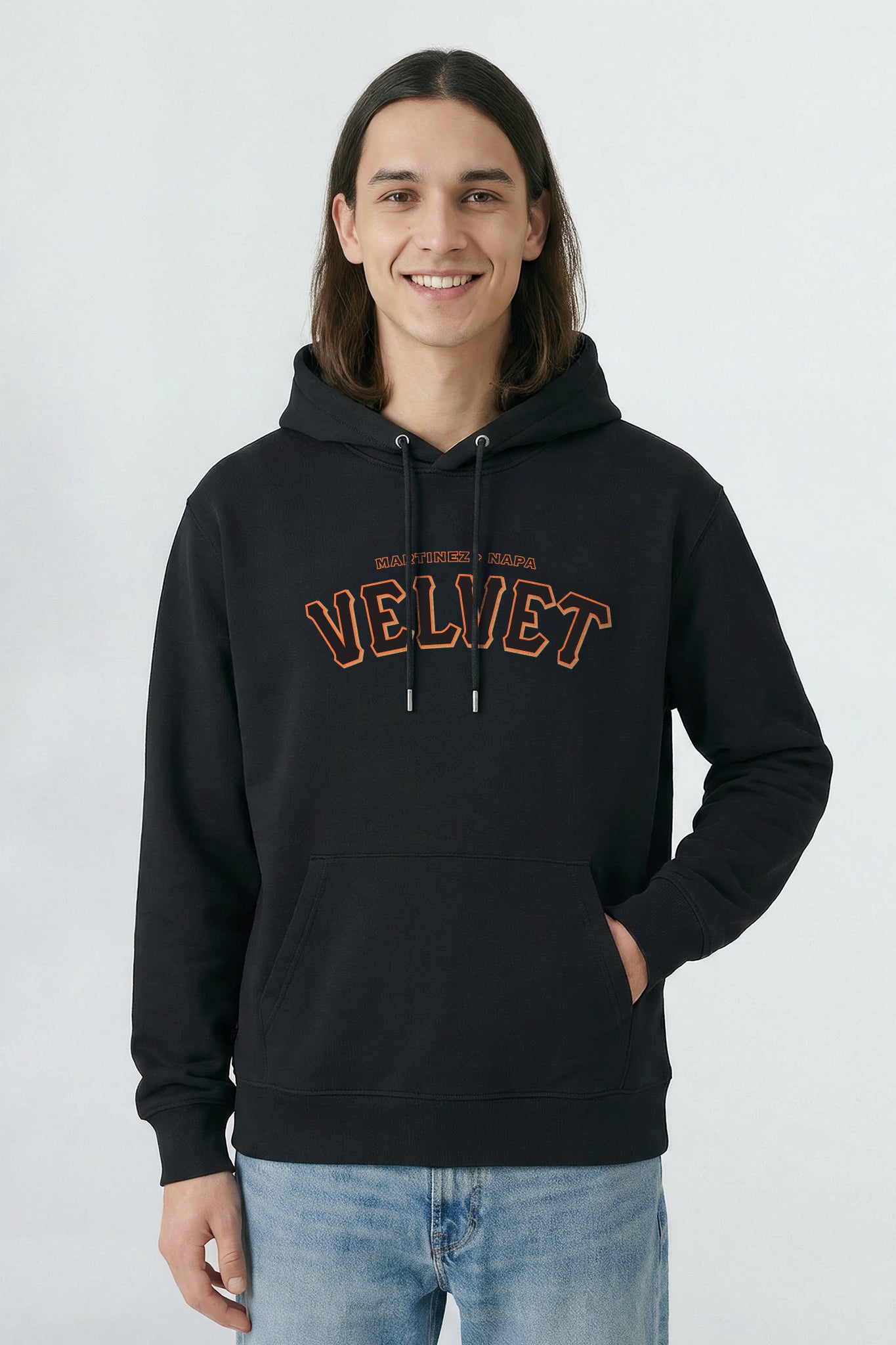 Person wearing a black hoodie with 'Velvet' text on a light background