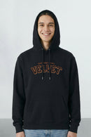 Person wearing a black hoodie with 'Velvet' text on a light background