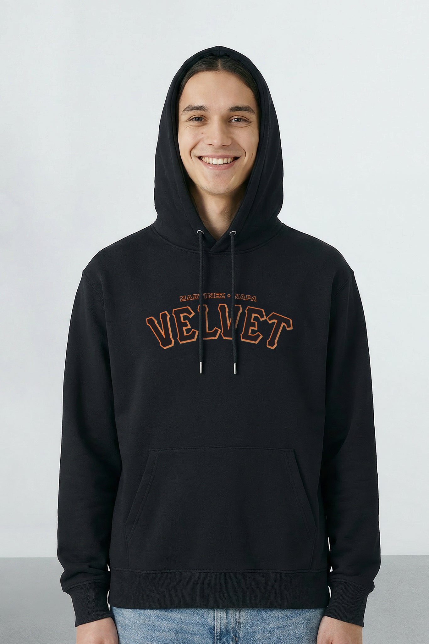 Person wearing a black hoodie with 'Velvet' text on a light background