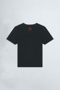 Black t-shirt with a logo on the chest against a gray background