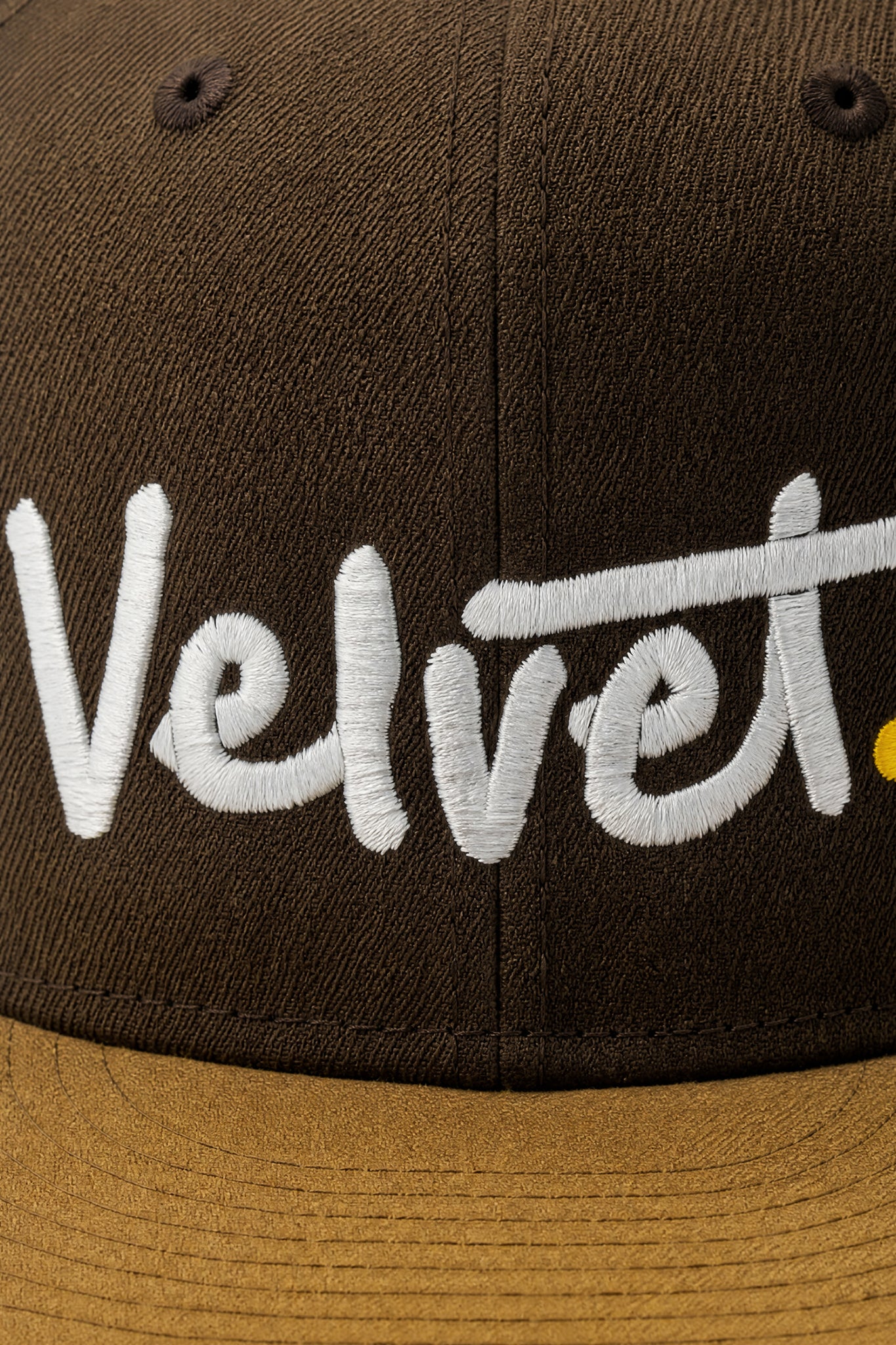 Brown cap with 'Velvet' embroidered in white on a dark background