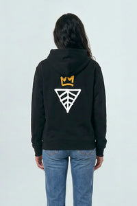 Person wearing a black hoodie with a logo on the back against a light background