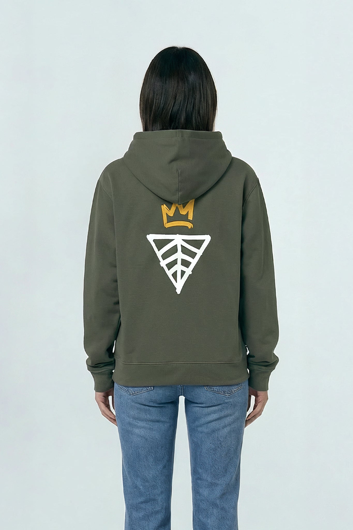 Person wearing a Khaki green hoodie with a logo on the back against a light background