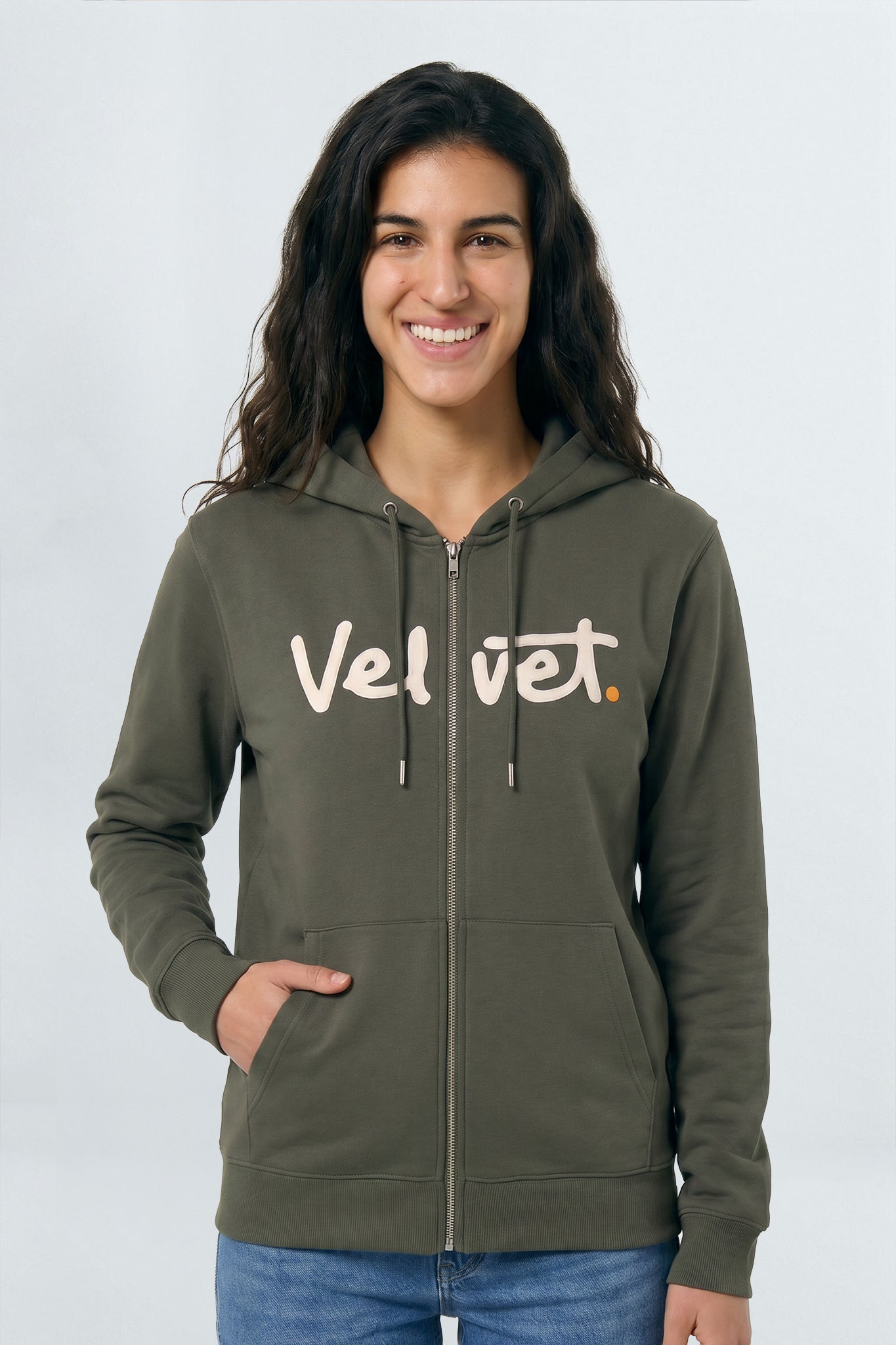 Woman wearing a Khaki green hoodie with 'Velvet' logo on a light background