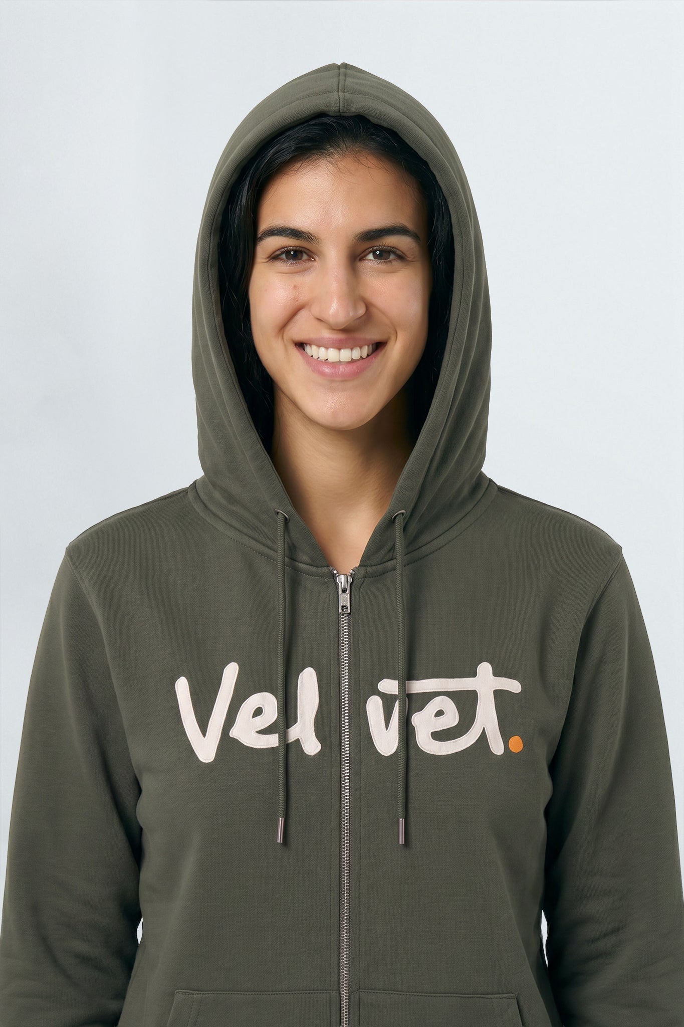 Person wearing a Khaki green hoodie with 'Velvet' text on a plain background