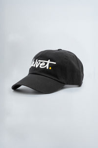 Black cap with white text on a light gray background