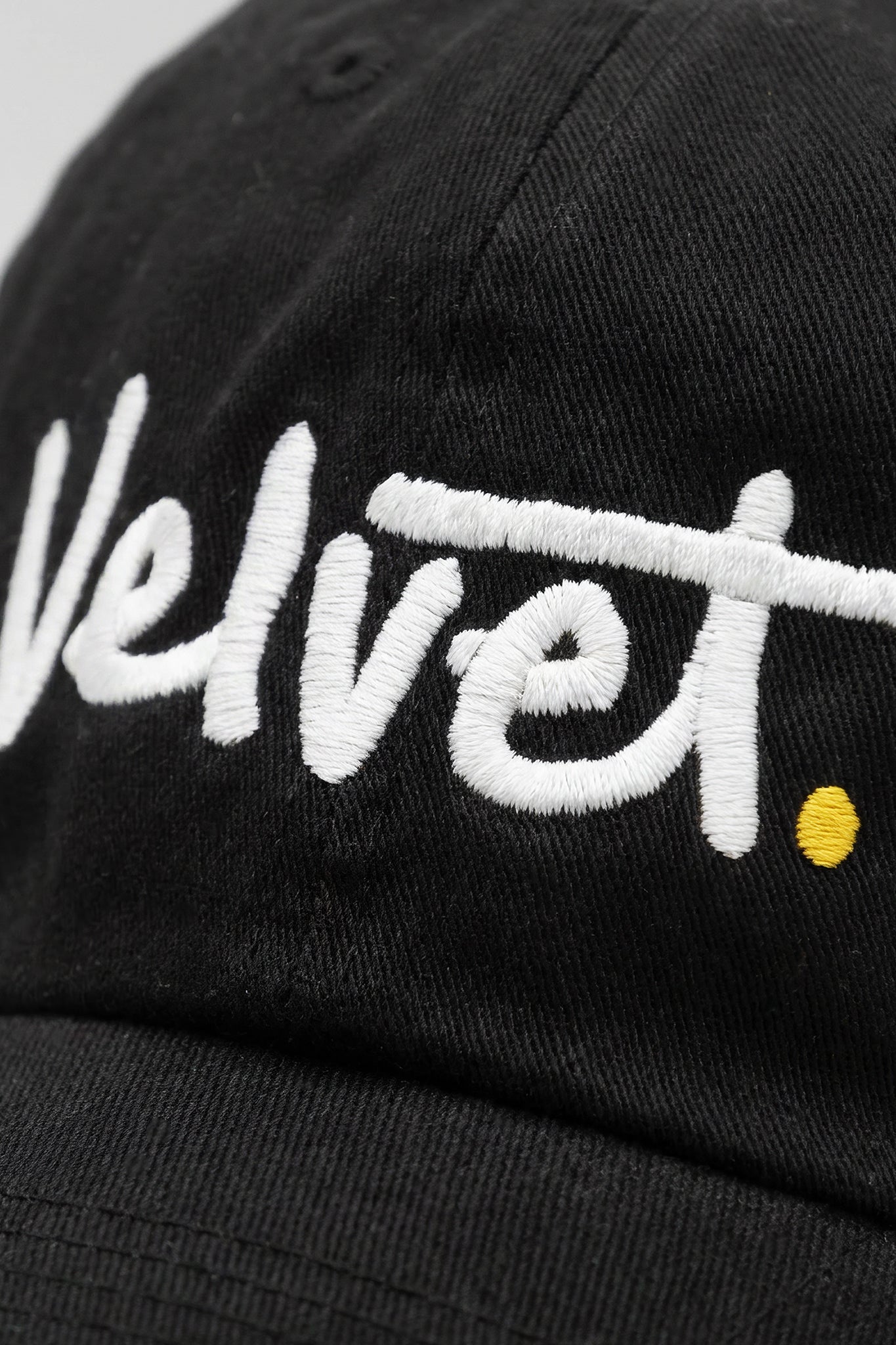 Black cap with 'Velvet.' embroidered in white on a plain background