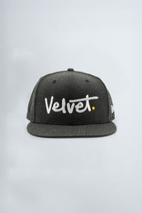 Black cap with 'Velvet' logo on a light background