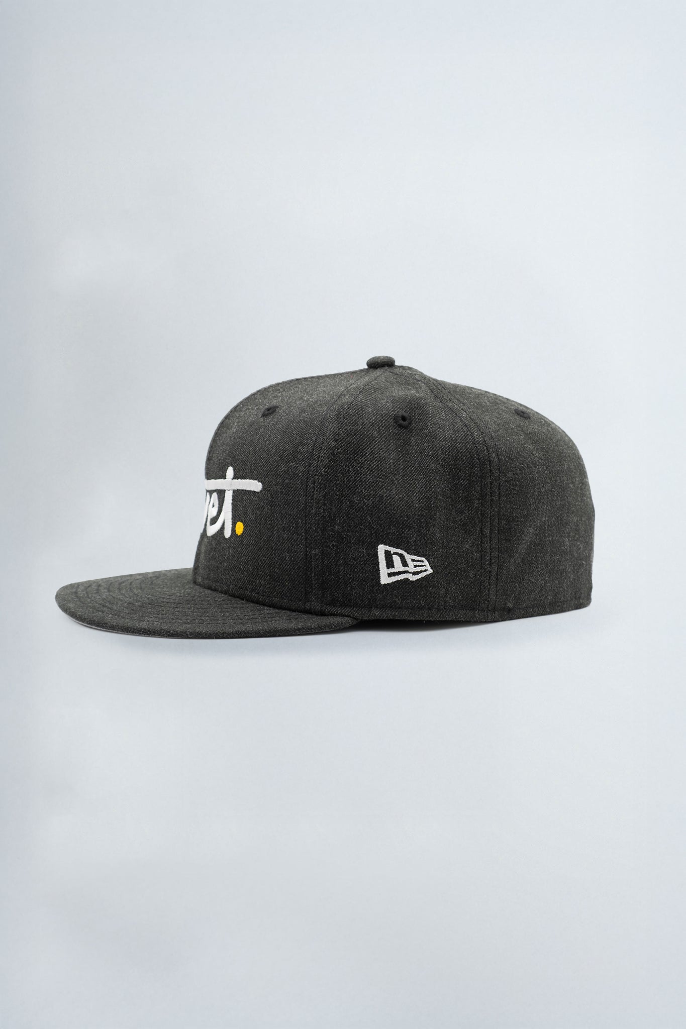 Black cap with white logo on a light background