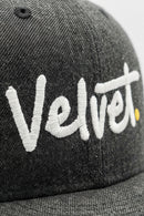 Gray cap with 'Velvet' embroidered in white on a light background