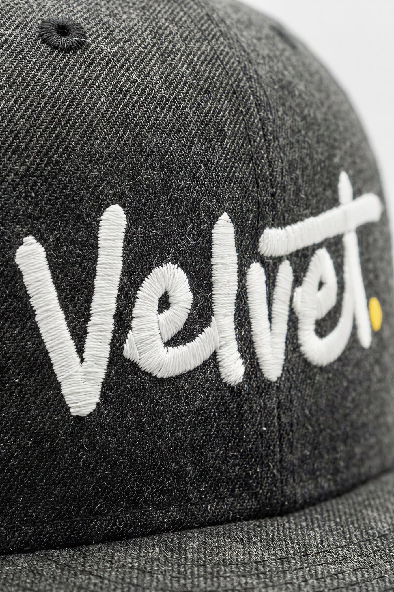 Gray cap with 'Velvet' embroidered in white on a light background