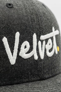 Gray cap with 'Velvet' embroidered in white on a light background