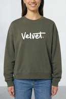 Person wearing a Khaki green sweatshirt with 'Velvet' logo on a plain background