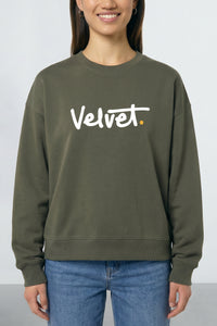 Person wearing a Khaki green sweatshirt with 'Velvet' logo on a plain background