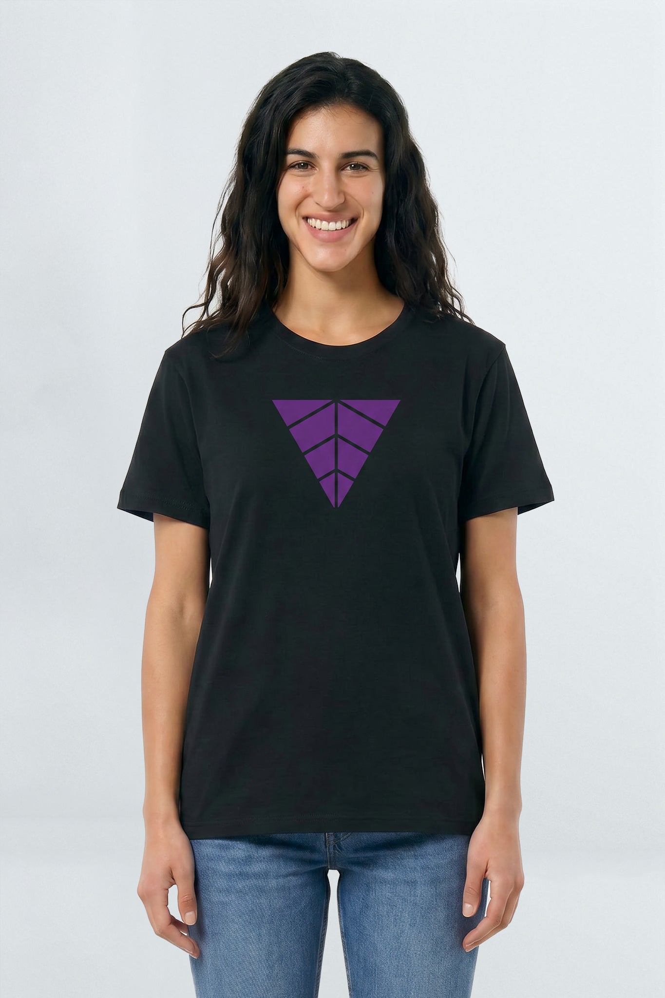 Woman wearing a black t-shirt with a purple geometric design on a light background