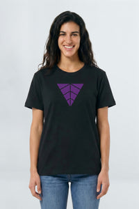 Woman wearing a black t-shirt with a purple geometric design on a light background