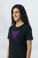 Person wearing a black t-shirt with a purple logo on a light  background