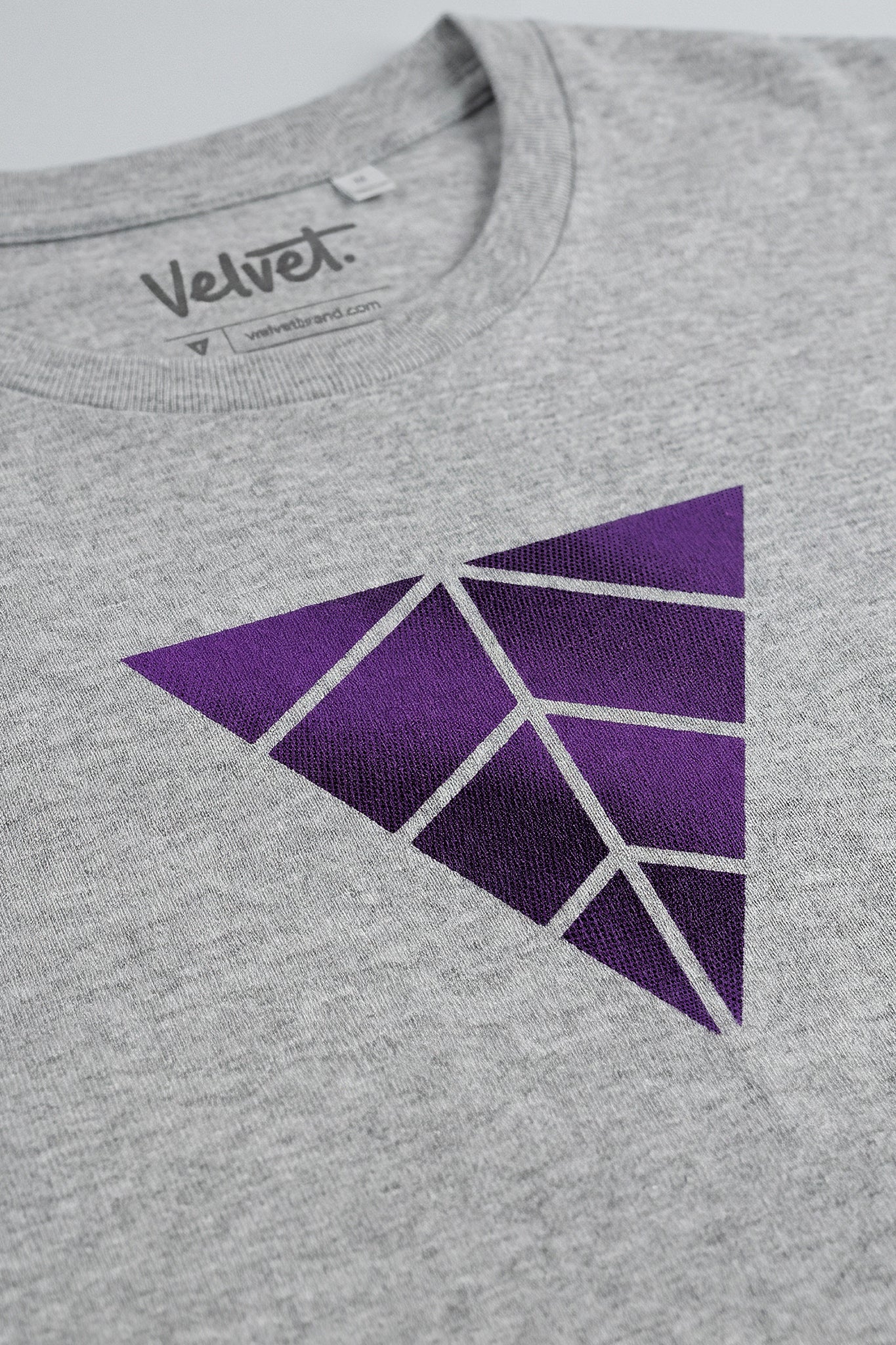 Heather gray t-shirt with a purple geometric triangle design on a light background