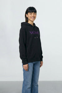 Person wearing a black hoodie with purple text on a light background