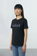 Person wearing a black t-shirt with 'velvet' text on a plain background