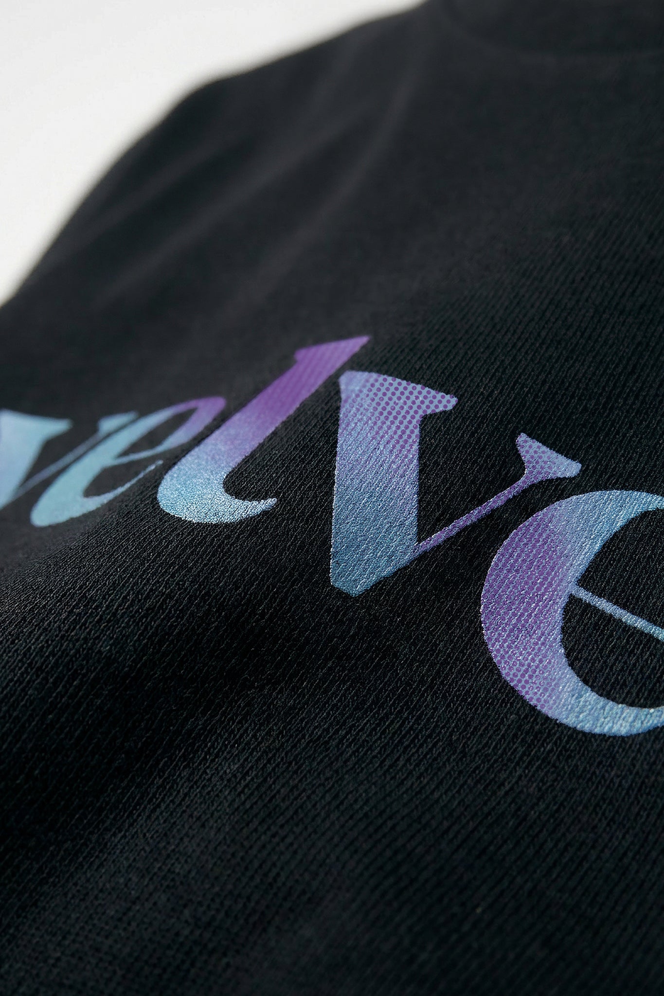 Black fabric with 'velvet' text in gradient colors on a light background