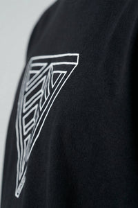 Black t-shirt with a geometric triangle design on a plain background