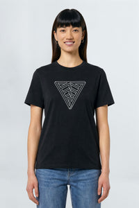 Person wearing a black t-shirt with a geometric triangle design on a plain background