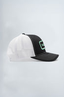 White and black cap with green logo on a light background