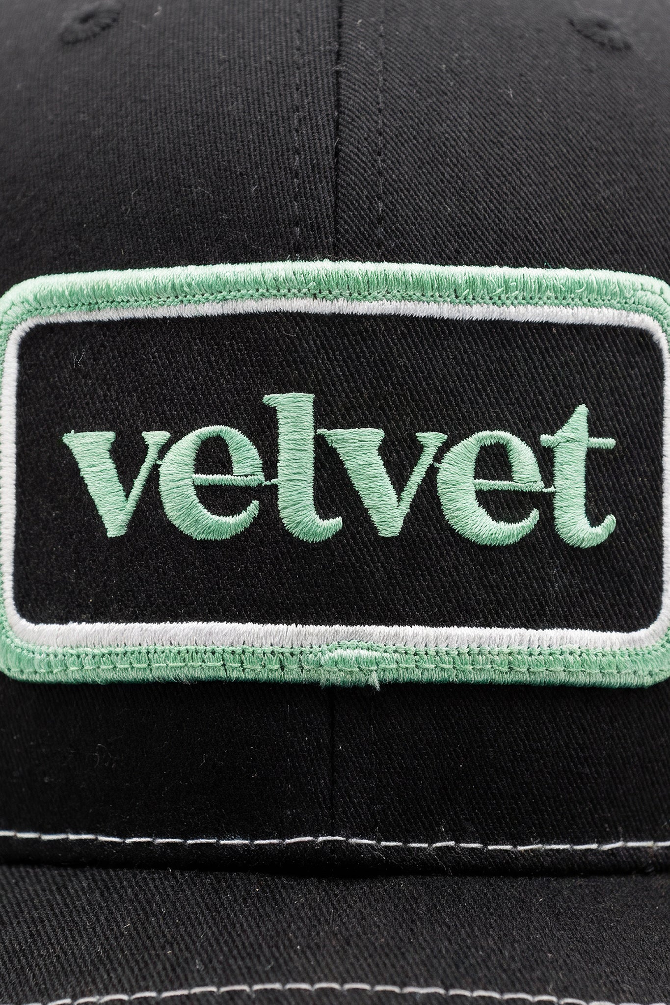 Black cap with a green 'velvet' patch