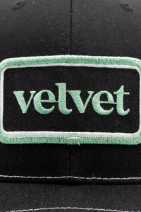 Black cap with a green 'velvet' patch