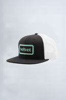 Black and white cap with 'velvet' logo on a light background