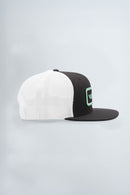Two-tone black and white cap with a green logo on a light background