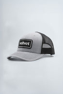 Gray and black cap with 'Velvet' logo on a light gray background