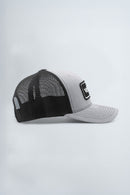 Black and gray trucker cap with a logo on a light gray background
