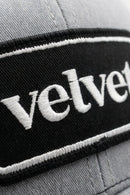 Gray cap with 'velvet' embroidered on a black band
