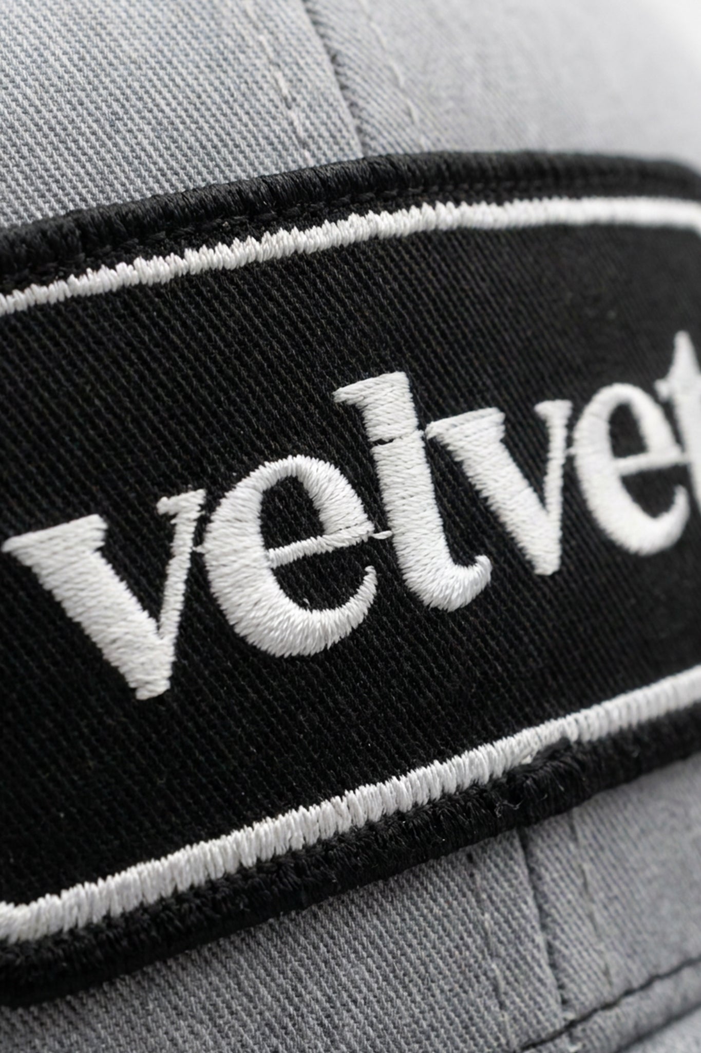 Gray cap with 'velvet' embroidered on a black band