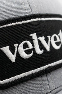 Gray cap with 'velvet' embroidered on a black band