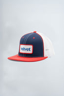 Trucker hat with red, white, and blue color scheme on a light gray background