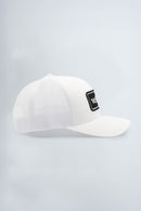 White cap with a black logo patch on a light background