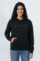 Woman wearing a black hoodie with 'velvet' text on a light background