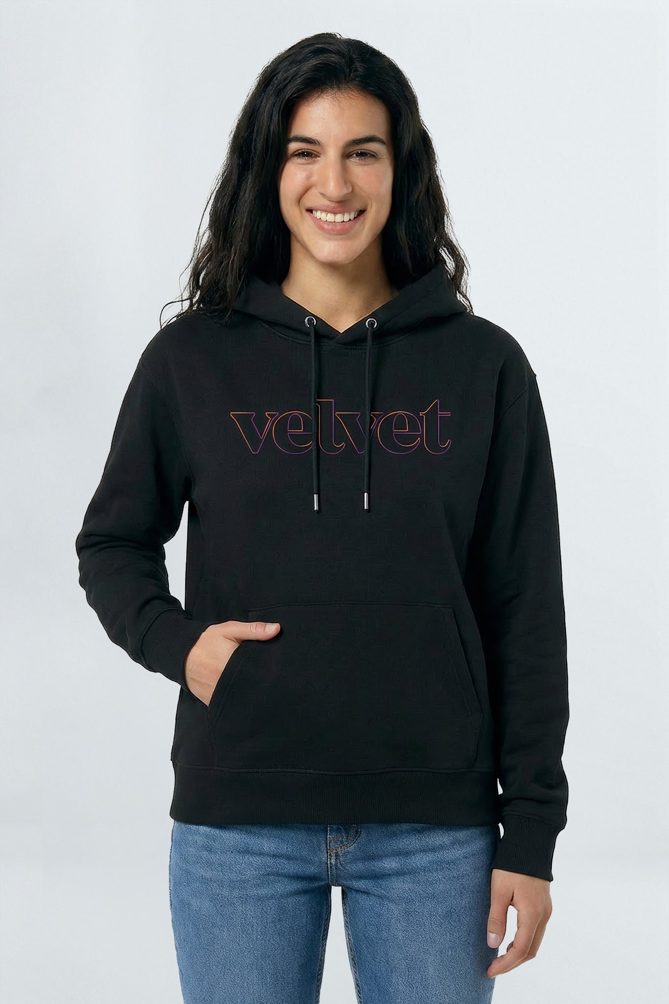 Woman wearing a black hoodie with 'velvet' text on a light background
