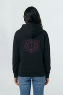 Person wearing a black hoodie with a geometric design on the back against a light background
