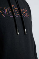 Black hoodie with colorful 'velvet' text on a light background