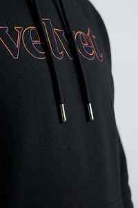 Black hoodie with colorful 'velvet' text on a light background