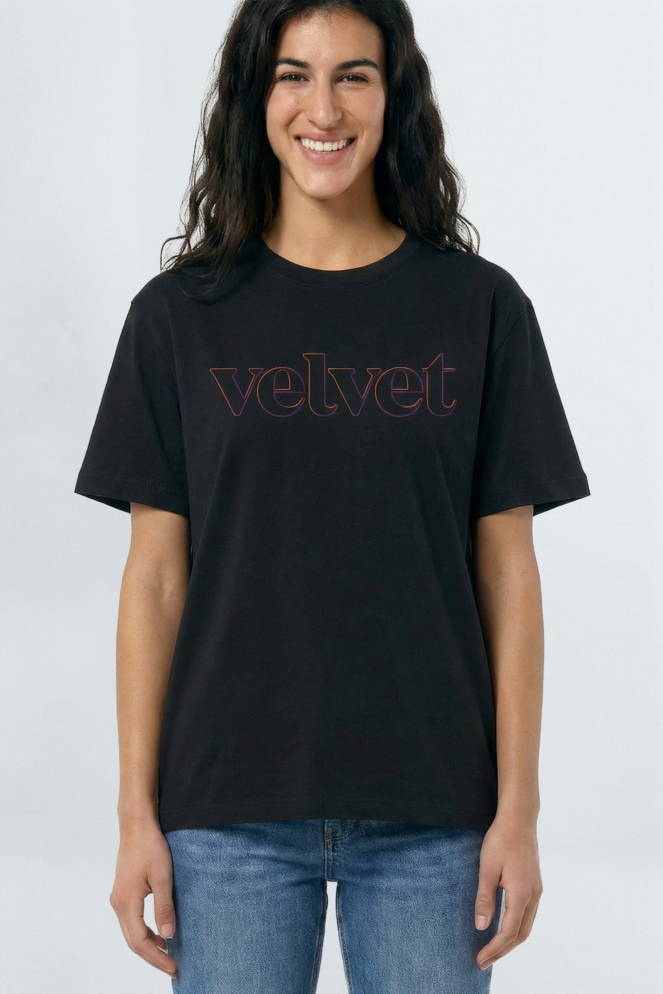 Person wearing a black t-shirt with 'velvet' text on a light
 background