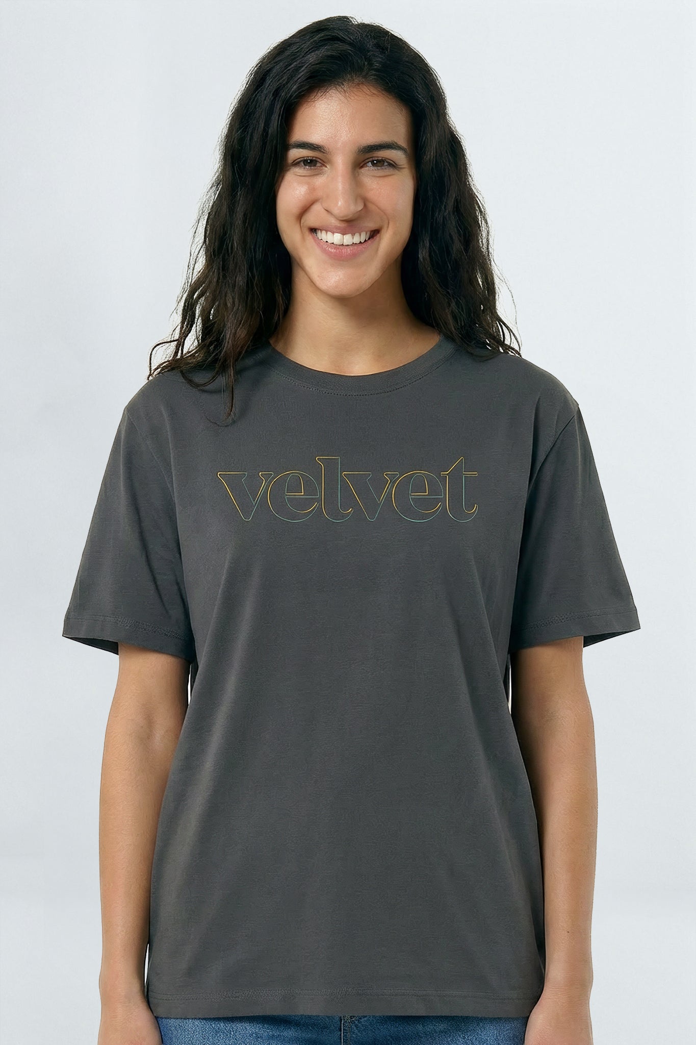 Person wearing a gray t-shirt with 'velvet' text on a light background