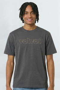 Man wearing a gray t-shirt with 'velvet' text on a background