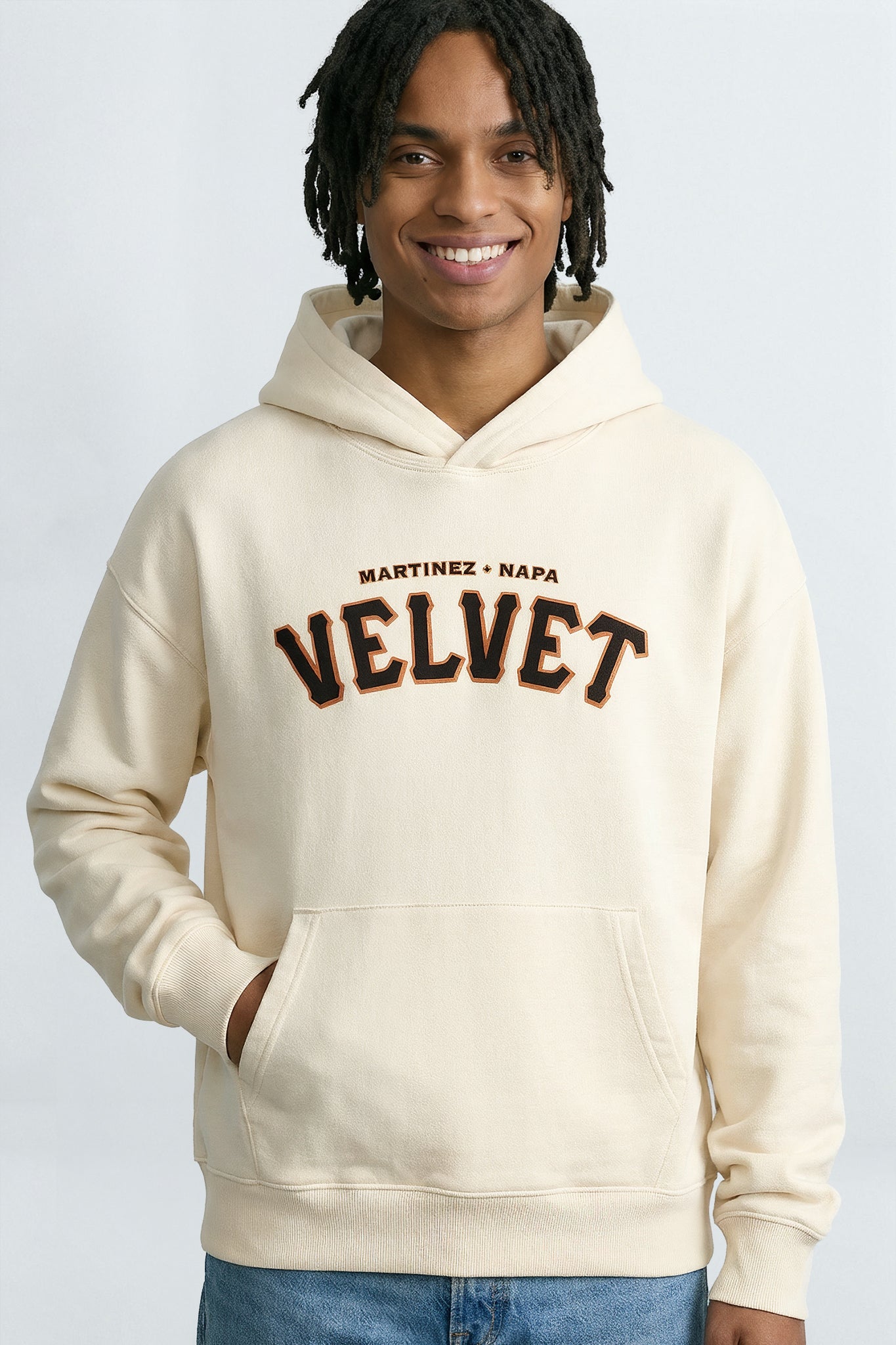 Person wearing a  cream hoodie with text on a light background