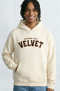 Person wearing a  cream hoodie with text on a light background